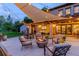 Inviting backyard patio with a cozy fire pit and comfortable seating under string lights at 9678 E Powers Dr, Greenwood Village, CO 80111
