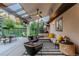 Back patio with a cozy lounge area, outdoor dining space, and serene backyard views at 9678 E Powers Dr, Greenwood Village, CO 80111