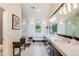 Luxurious bathroom showcasing modern fixtures, an oversized mirror, and an elegant soaking tub at 9678 E Powers Dr, Greenwood Village, CO 80111