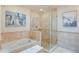 This bathroom is modern with a soaking tub and glass shower with tiled surround at 9678 E Powers Dr, Greenwood Village, CO 80111