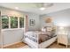 Bright bedroom with a comfy bed, big window view, and charming details at 9678 E Powers Dr, Greenwood Village, CO 80111