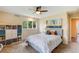 This bedroom features a ceiling fan, and large windows that provide ample natural light at 9678 E Powers Dr, Greenwood Village, CO 80111