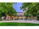 Beautiful two-story home featuring a stone facade, manicured landscaping, and a tranquil setting surrounded by mature trees at 9678 E Powers Dr, Greenwood Village, CO 80111