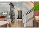 Stylish foyer with hardwood floors, modern lighting, and a staircase, seamlessly connecting to the home's living spaces at 9678 E Powers Dr, Greenwood Village, CO 80111