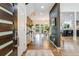 Bright foyer with hardwood floors, a modern staircase, and a view into the dining and living areas at 9678 E Powers Dr, Greenwood Village, CO 80111