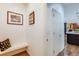 Hallway with wooden floors, coat rack, and a view into the kitchen at 9678 E Powers Dr, Greenwood Village, CO 80111