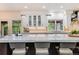 Bright, modern kitchen with a large island, white cabinetry, and stainless steel appliances at 9678 E Powers Dr, Greenwood Village, CO 80111
