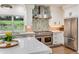 Modern kitchen with stainless steel appliances, custom backsplash, and a large marble island at 9678 E Powers Dr, Greenwood Village, CO 80111