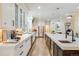 Modern kitchen with sleek countertops, stainless steel appliances, custom cabinetry, and hardwood flooring at 9678 E Powers Dr, Greenwood Village, CO 80111