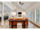 Inviting living room with vaulted ceilings, large windows, and a stone fireplace at 9678 E Powers Dr, Greenwood Village, CO 80111