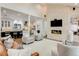 Spacious living room with a stone fireplace and an open layout to the kitchen at 9678 E Powers Dr, Greenwood Village, CO 80111