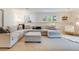 Cozy living room featuring a large sectional sofa, plush carpet, and natural light at 9678 E Powers Dr, Greenwood Village, CO 80111