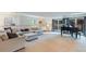 Spacious living room with grand piano, plush seating, and access to the outdoor patio at 9678 E Powers Dr, Greenwood Village, CO 80111