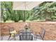 Outdoor patio features a table with four chairs, surrounded by lush landscaping and greenery at 9678 E Powers Dr, Greenwood Village, CO 80111