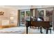 A grand piano sits center stage in a room with outdoor access and soft natural light at 9678 E Powers Dr, Greenwood Village, CO 80111