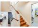 Elegant staircase with wood treads, white risers and banister, connecting the home's levels at 9678 E Powers Dr, Greenwood Village, CO 80111