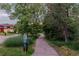 This walking path is shaded by mature trees at 9678 E Powers Dr, Greenwood Village, CO 80111