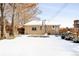 House exterior and backyard with snow-covered lawn at 1171 Quebec St, Denver, CO 80220