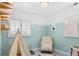 bedroom features mint and white painted walls, a tent, and a chair at 1171 Quebec St, Denver, CO 80220