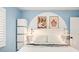 Stylish bedroom featuring a queen-sized bed, artistic decor, and modern lighting fixtures at 1171 Quebec St, Denver, CO 80220