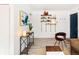 Entryway with stylish console table, wall shelving, and a navy door at 1171 Quebec St, Denver, CO 80220