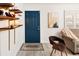 Inviting entryway with a stylish blue door, coat rack, and wood-look flooring at 1171 Quebec St, Denver, CO 80220