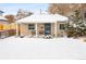 Charming bungalow with snow-covered front yard and welcoming porch at 1171 Quebec St, Denver, CO 80220