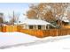 Tan stucco house with a snow-covered yard at 1171 Quebec St, Denver, CO 80220