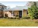 Inviting single-story home with a covered front porch, well-maintained landscaping, and green lawn at 1171 Quebec St, Denver, CO 80220