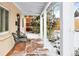 Inviting front porch with wooden flooring and black metal chairs at 1171 Quebec St, Denver, CO 80220