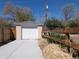 View of detached one car garage with white door and concrete driveway at 1171 Quebec St, Denver, CO 80220