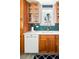 Kitchen detail showcasing cabinets, sink and window at 1171 Quebec St, Denver, CO 80220