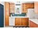 Well-lit kitchen featuring honey-colored cabinets, white countertops, and modern appliances at 1171 Quebec St, Denver, CO 80220