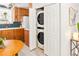 Convenient laundry closet with a stacked washer and dryer in kitchen area at 1171 Quebec St, Denver, CO 80220