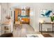 Bright and airy living room flowing into the kitchen featuring modern decor and stylish furnishings at 1171 Quebec St, Denver, CO 80220