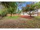 Landscaped backyard offering a blend of green lawn and decorative mulch beneath mature trees at 2108 S Idalia St, Aurora, CO 80013