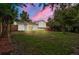 Spacious backyard featuring lush grass, mature trees, and a well-maintained fence at 2108 S Idalia St, Aurora, CO 80013