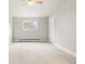 A well-lit bedroom features neutral walls, carpet and a large window, creating a cozy and inviting atmosphere at 2108 S Idalia St, Aurora, CO 80013