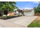 Charming exterior with manicured lawn, mature tree, and a long, paved driveway at 2108 S Idalia St, Aurora, CO 80013