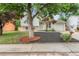Charming front yard with lush trees, decorative mulch, and a well-maintained lawn at 2108 S Idalia St, Aurora, CO 80013