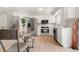 Bright kitchen with stainless steel appliances, white cabinets, and an adjacent staircase at 2108 S Idalia St, Aurora, CO 80013