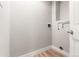 A practical laundry room featuring connections, outlets, and modern wood flooring, ensuring convenience at 2108 S Idalia St, Aurora, CO 80013