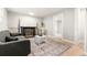A comfortable living room is showcased, featuring a decorative fireplace, plush seating, and a stylish rug at 2108 S Idalia St, Aurora, CO 80013