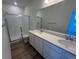Bathroom featuring double vanity, shower, and tile floors at 6638 N Nepal Ct, Aurora, CO 80019
