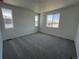 Spacious carpeted bedroom with plenty of natural light from multiple windows at 6638 N Nepal Ct, Aurora, CO 80019