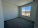 Carpeted bedroom with a large window offering views of the neighborhood at 6638 N Nepal Ct, Aurora, CO 80019