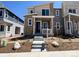 Inviting two-story home featuring stone accents, neutral tones, and well-manicured landscaping at 6638 N Nepal Ct, Aurora, CO 80019
