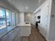 Modern kitchen features a large center island, stainless steel appliances, and sliding doors to a deck at 6638 N Nepal Ct, Aurora, CO 80019