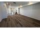 Open-concept living room featuring wood-look floors, recessed lighting, and an adjacent kitchen at 6638 N Nepal Ct, Aurora, CO 80019
