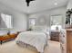 Bright bedroom features a king bed, two windows, and neutral decor at 1303 Jersey St, Denver, CO 80220